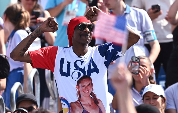 Rapper Snoop Dogg wears a T-shirt with Kelly Cheng on it as he dances before a beach volleyball match on July 31.