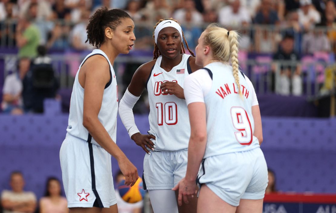 Burdick, Howard and Van Lith hold a huddle during the game.