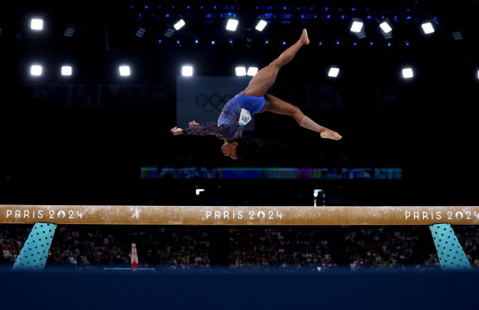 Simone Biles competes on the balance beam during the individual all-around at the Paris Olympics in August 2024. She won gold.