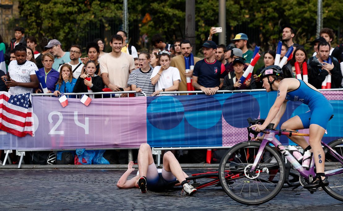 Italy's Verena Steinhauser rides past a fallen athlete during the women's individual triathlon on July 31.