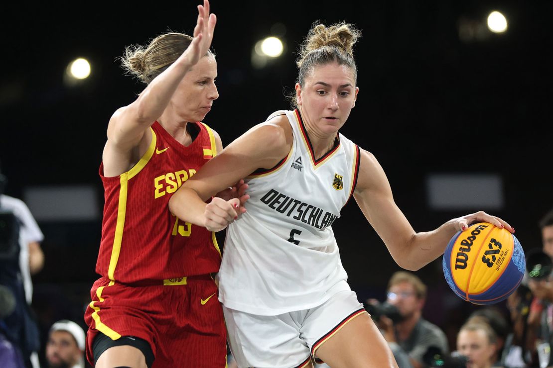 Germany's Marie Reichert takes the ball to the hoop against Spain's Sandra Ygueravide in the women's 3x3 basketball gold medal game.