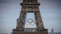 FILE - The Olympic rings are seen on the Eiffel Tower, Sunday, July 14, 2024, in Paris. Five players on Australia's women's water polo team for the Paris Olympics have tested positive for COVID-19. (AP Photo/Aurelien Morissard, File)