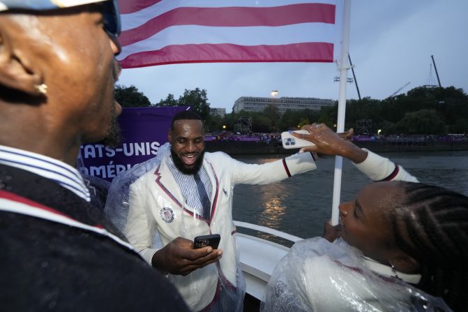 US flag bearers LeBron James and Coco Gauff travel with other American athletes during the Parade of Nations, which took place on boats in the Seine River.