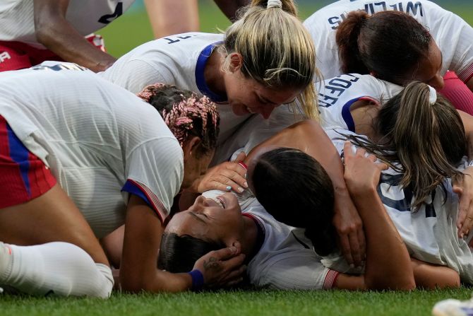 US soccer player Sophia Smith is mobbed by teammates after scoring an extra-time goal against Germany on Tuesday, August 6. The Americans won 1-0 to advance to the gold-medal match.