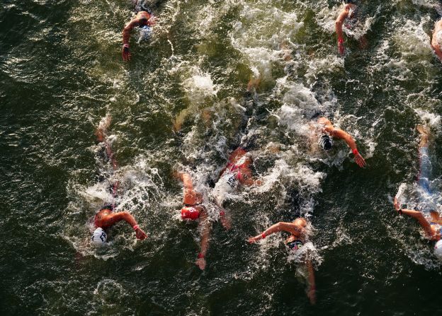 Competitors swim in the Seine River during the women's 10-kilometer marathon on August 8. The water quality of the river has been an <a href="https://cnn.com/2024/08/07/sport/claire-michel-belgian-triathlete-ill-ecoli-spt/index.html">ongoing saga</a> at the Games, but organizers deemed it fit for athletes to race in.