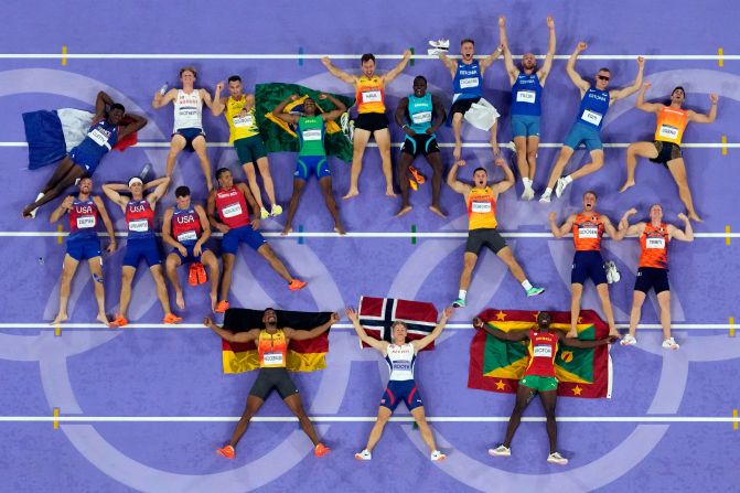 Decathlon silver medalist Leo Neugebauer of Germany, gold medalist Markus Rooth of Norway and bronze medalist Lindon Victor of Grenada, bottom row, lay on the track with fellow competitors after completing the last event August 3. Rooth brought home <a href="https://www.cnn.com/sport/live-news/paris-olympics-news-2024-08-03#h_9c00eb3c8d1e6ed8000070bcdc89745d">Norway's first medal</a> at the Paris Games.