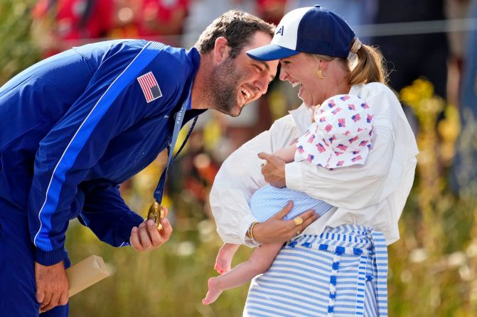 American golfer <a href="https://www.cnn.com/2024/05/17/sport/scottie-scheffler-profile-pga-championship-spt-intl/index.html">Scottie Scheffler </a>celebrates with his wife, Meredith Scudder, and child after <a href="https://www.cnn.com/sport/live-news/paris-olympics-news-2024-08-04#h_085163c018b75c8cb2f88dd807ccc31a">winning the gold medal</a> in men’s individual stroke play August 4.