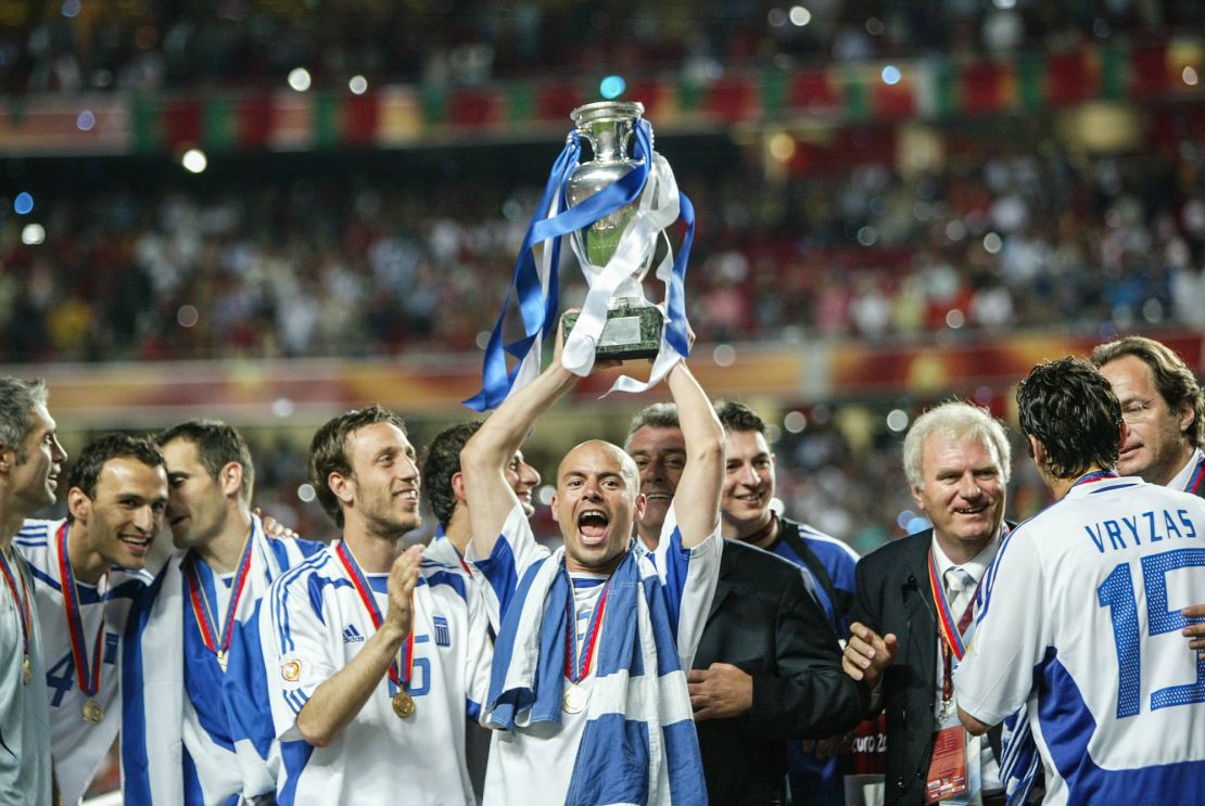 Stelios Giannakopoulos celebrates on the pitch after lifting the Euro 2004 title.