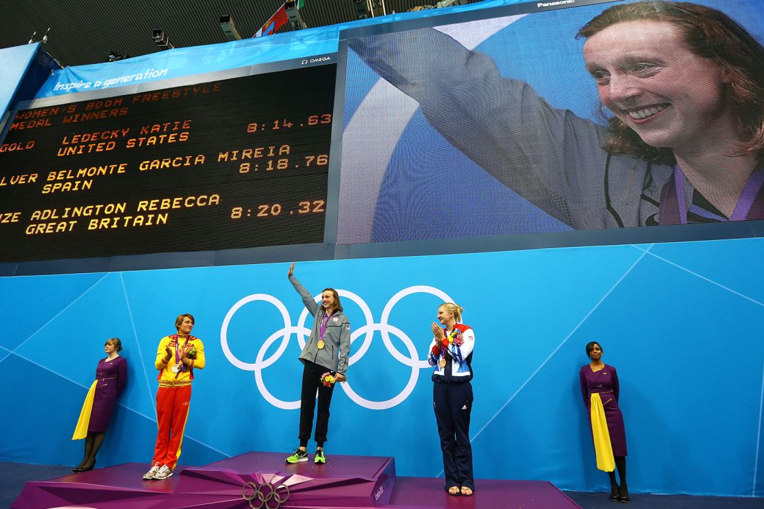 Katie Ledecky (center) waves to the crowd on the podium at London 2012.