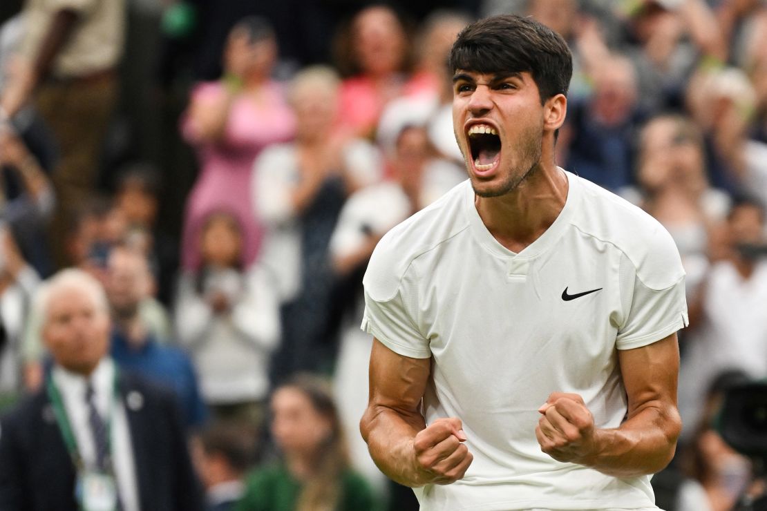 Alcaraz celebrates winning against Frances Tiafoe.