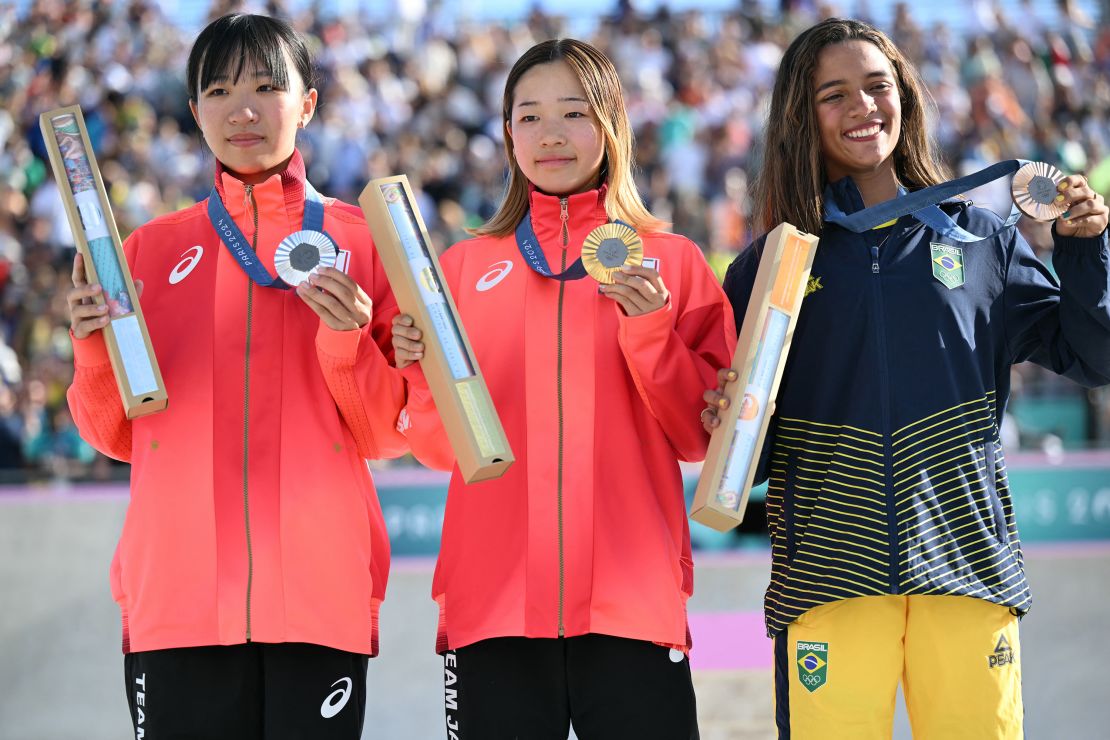 Gold medallist Japan's Coco Yoshizawa (C), silver medallist Japan's Liz Akama (L) and bronze medallist Brazil's Rayssa Leal stand on the podium during the victory ceremony for the women's street skateboarding event during the Paris 2024 Olympic Games at La Concorde in Paris on July 28, 2024. (Photo by Kirill KUDRYAVTSEV / AFP) (Photo by KIRILL KUDRYAVTSEV/AFP via Getty Images)