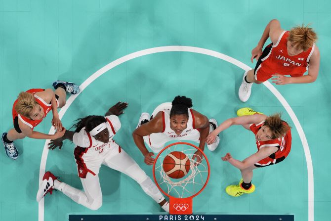 From left, Japan's Saori Miyazaki, the United States' Kahleah Copper, the United States' Alyssa Thomas, Japan's Saki Hayashi and Japan's Maki Takada watch the ball go through the hoop during their first basketball game in Paris on July 29. <a href="https://www.cnn.com/sport/live-news/paris-olympics-news-2024-07-29#h_84e113914114770876ceaa3036a15320">Team USA won 102-76</a> in what was a rematch of the gold-medal game three years ago. The United States has won 56 consecutive Olympic games.