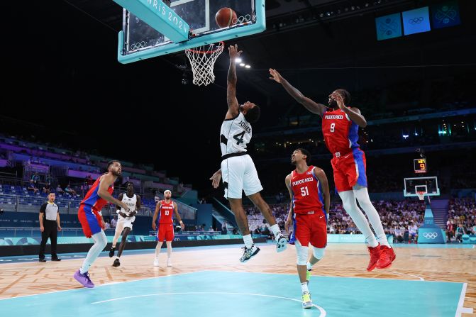 South Sudanese basketball player Carlik Jones drives to the basket during a game against Puerto Rico on July 28. South Sudan claimed a <a href="https://www.cnn.com/sport/live-news/paris-olympics-news-2024-07-28#h_c0270c5dd556a54f630fdf3c800a1bfd">historic victory</a> in its first-ever Olympic men's game, winning 90-79.