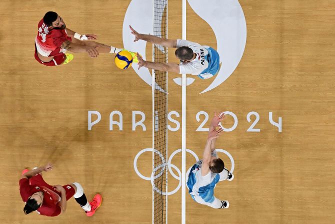 France's Nicolas Le Goff tries to hit the ball past Slovenia's Alen Pajenk during a volleyball match on August 2.