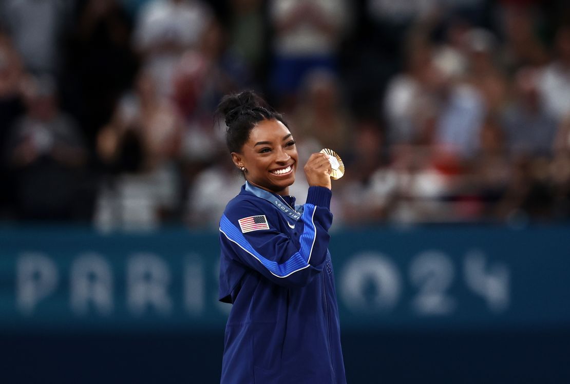 Gold medalist Simone Biles of Team United States poses with her medal after competing in the Artistic Gymnastics Women's All-Around Final on day six of the Olympic Games Paris 2024 at Bercy Arena on August 1, 2024 in Paris, France.