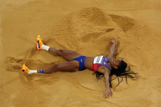 American long jumper Tara Davis-Woodhall celebrates in the sand <a href="https://www.cnn.com/sport/live-news/paris-olympics-news-2024-08-08#h_868d41b29914d80333e85fe5b69ae2b2">after winning gold</a> on August 8.