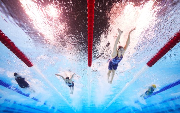 US swimmer Gretchen Walsh, second from right, <a href="https://www.cnn.com/sport/live-news/paris-olympics-news-2024-07-27#h_ebb32299890e7a9cd932e5751ceef68d">set a new Olympic record in the 100-meter butterfly</a> during a semifinal race on July 27. She finished in 55.38 seconds.