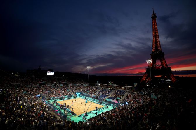 The sun sets behind the Eiffel Tower during a beach volleyball match on July 27.