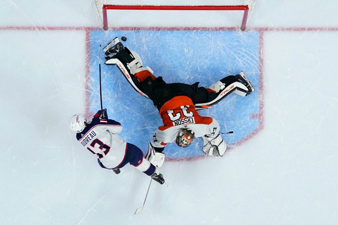 Columbus Blue Jackets' Johnny Gaudreau, left, scores a goal against Philadelphia Flyers' Samuel Ersson during a shootout on January 4, in Philadelphia.