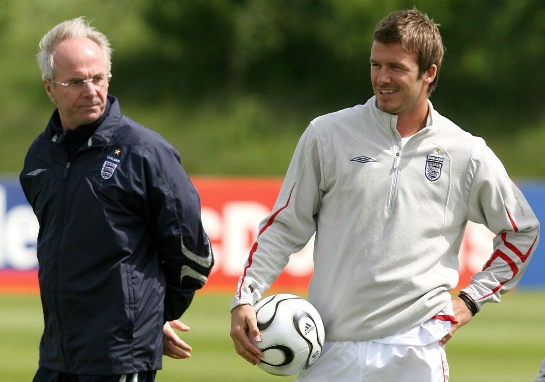 Eriksson (left) looks over an England training session next to David Beckham (right).