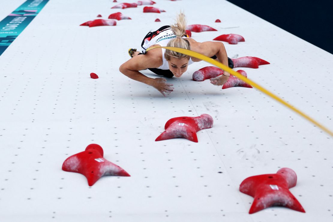 Mirosław races to the top of the wall at the Paris Olympics.