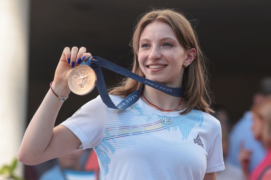 Romanian gymnast Ana Barbosu shows the media the Olympic bronze medal she was handed just minutes before, in Bucharest, Romania, August 16, 2024. Inquam Photos/George Calin via REUTERS ATTENTION EDITORS - THIS IMAGE WAS PROVIDED BY A THIRD PARTY. ROMANIA OUT. NO COMMERCIAL OR EDITORIAL SALES IN ROMANIA