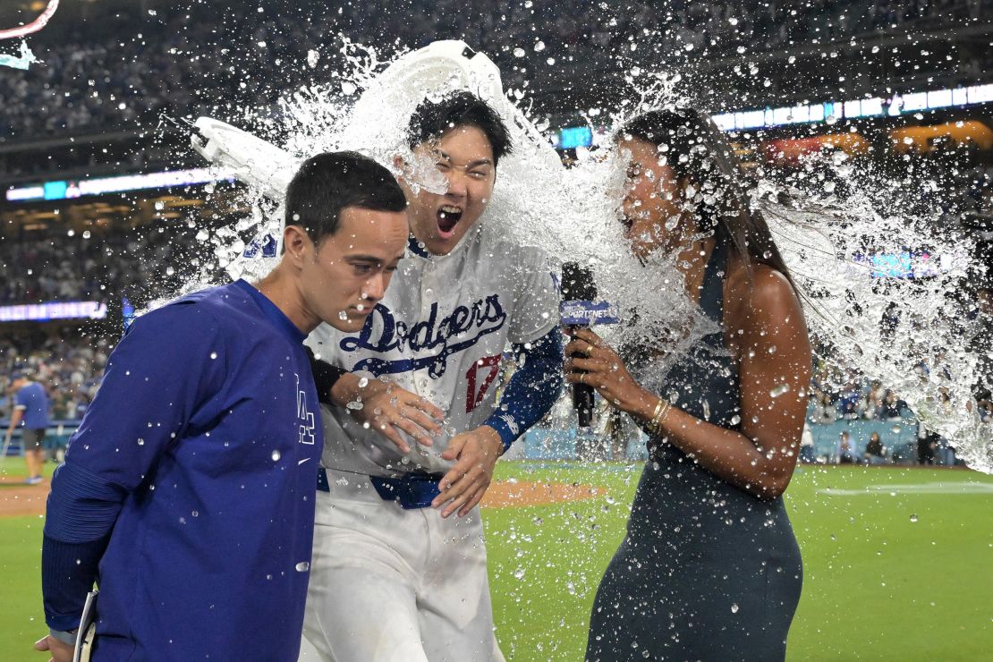 Los Angeles Dodgers designated hitter Shohei Ohtani, center, gets a cooler of ice water dumped on his head after hitting a grand slam walk off home run.