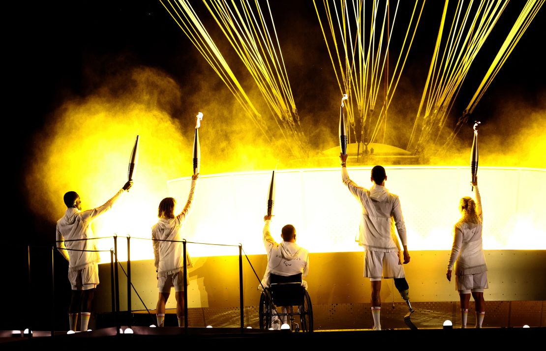 Paris 2024 Paralympics - Opening Ceremony - Paris, France - August 28, 2024 Charles-Antoine Kouakou, Nantenin Keita, Fabien Lamirault, Alexis Hanquinquant and Elodie Lorandi lit The Olympic cauldron REUTERS/Kacper Pempel