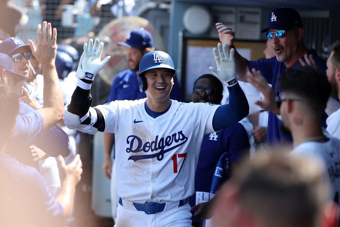 Dodgers DH Ohtani is greeted in the dugout after hitting his fifth-inning home run.