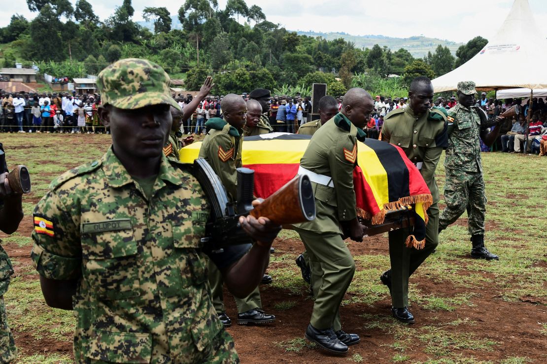 Soldiers from Uganda People's Defence Forces (UPDF) carry the flag-draped coffin of Cheptegei.