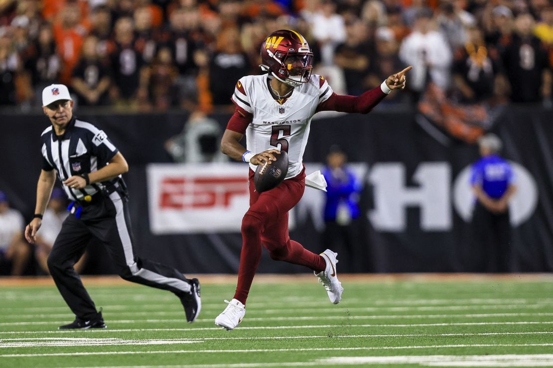 Sep 23, 2024; Cincinnati, Ohio, USA; Washington Commanders quarterback Jayden Daniels (5) runs with the ball against the Cincinnati Bengals in the first half at Paycor Stadium. Mandatory Credit: Katie Stratman-Imagn Images