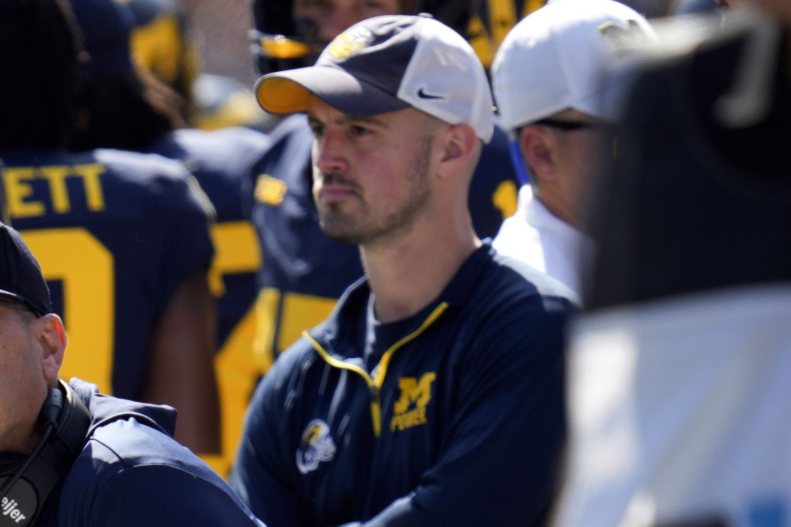 Michigan head coach Jim Harbaugh, front left, watches against Rutgers as analytics assistant Connor Stalions, right, looks on during an NCAA college football game in Ann Arbor, Mich., Sept. 23, 2023. Stalions was suspended by the university last week and is at the center of a sign-stealing scheme that is being investigated by the NCAA. (AP Photo/Paul Sancya)