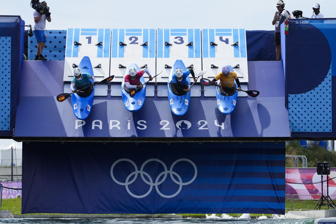 Athletes are dropped from a ramp into the water.