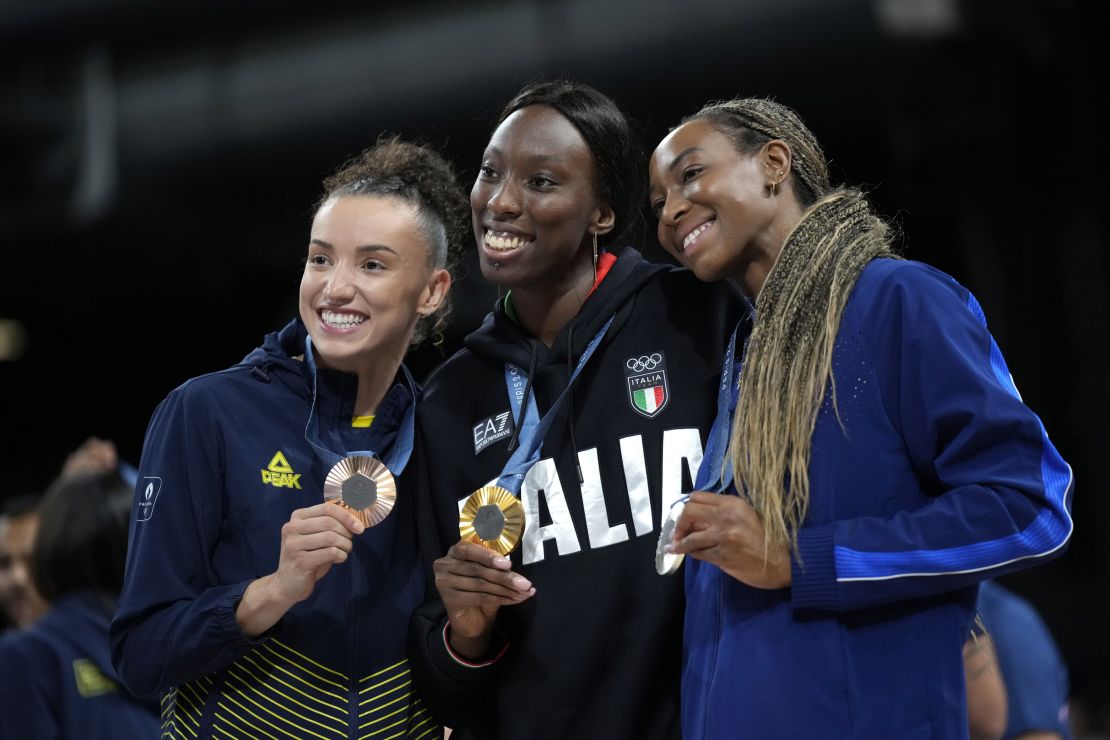 From left, Gabriela Braga of Brazil, Paola Egonu of Italy and Chiaka Ogbogu of the United States show their medals after a ceremony at the end of the women's volleyball final at the 2024 Summer Olympics in Paris on August 11, 2024.