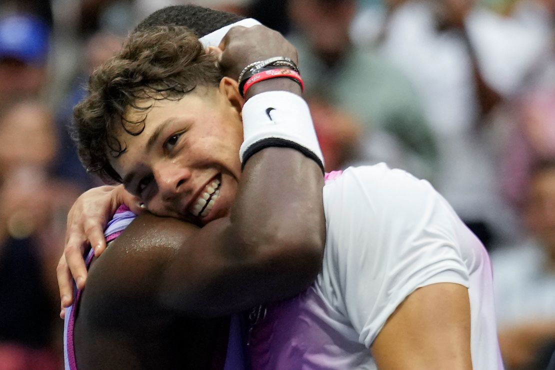 Tiafoe hugs Shelton at the net after Tiafoe's come-from-behind win Friday.