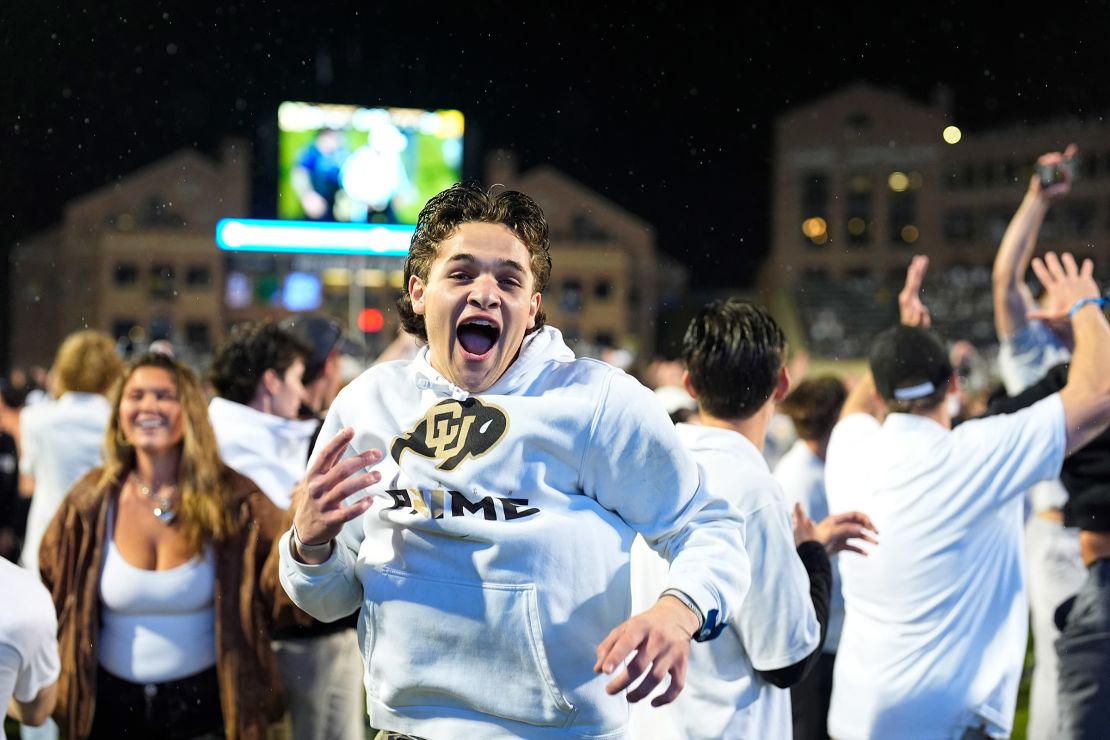 Colorado fans storm the playing field after the Buffaloes' overtime victory over Baylor.