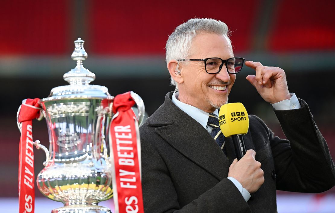 BBC presenter Gary Lineker looks on with the FA Cup trophy after the Emirates FA Cup Semi Final match between Manchester City and Chelsea at Wembley Stadium on April 20, 2024 in London, England.