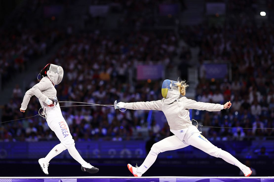 Jeon Eun-hye of South Korea and Kharlan compete during the fencing women's sabre team gold medal match at the Grand Palais on August 3.