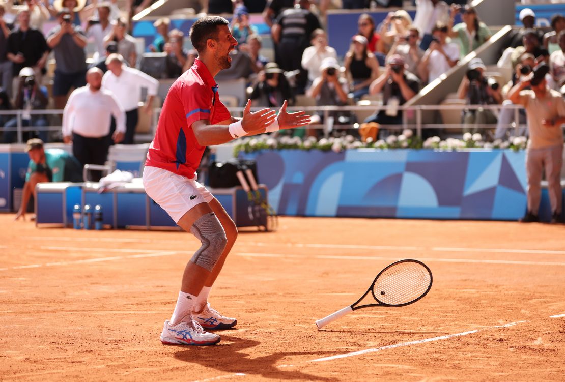 Djokovic celebrates winning match point against Alcaraz.