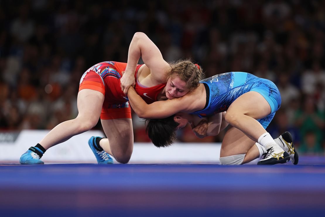 Elor (red) competes with Kyrgyzstan’s Meerim Zhumanazarova (blue) in the women's freestyle 68kg gold medal match at Champs-de-Mars Arena.