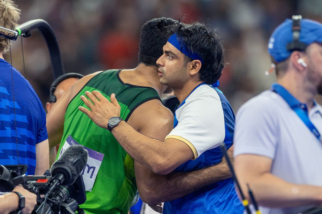 Arshad Nadeem of Pakistan and Neeraj Chopra of India embrace after their gold-silver medal finish at the 2024 Summer Olympic Games.