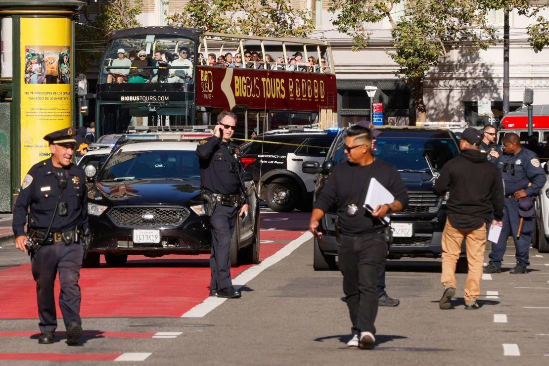 Police officers secure the area and investigate the scene of a shooting at Union Square in San Francisco on Saturday.