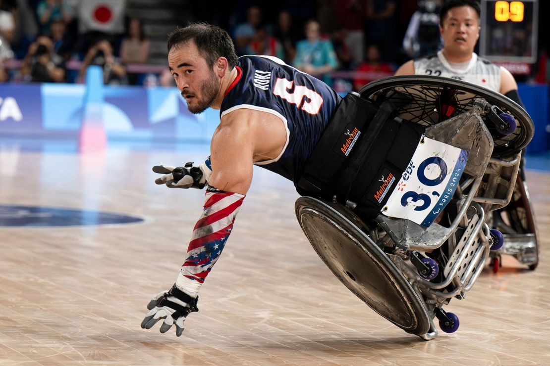 Chuck Aoki passes the ball as he competes in the final of the Open Wheelchair Rugby at the Champ de Mars Arena.