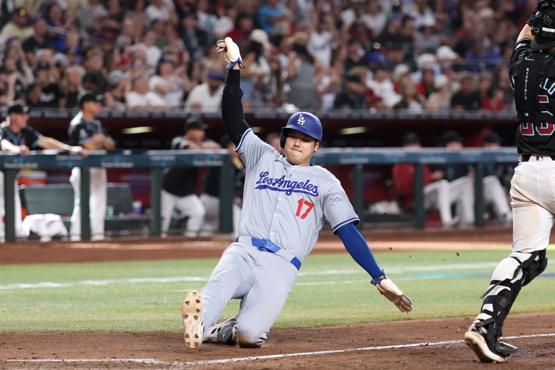 Ohtani safely slides at home plate to score a run during the eighth inning against the Arizona Diamondbacks.