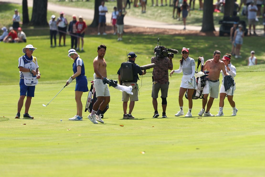 The caddies react to Lee's long-range hole out.