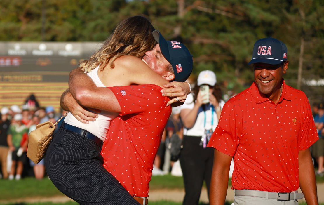 Bradley celebrates with his wife after clinching victory for Team USA.