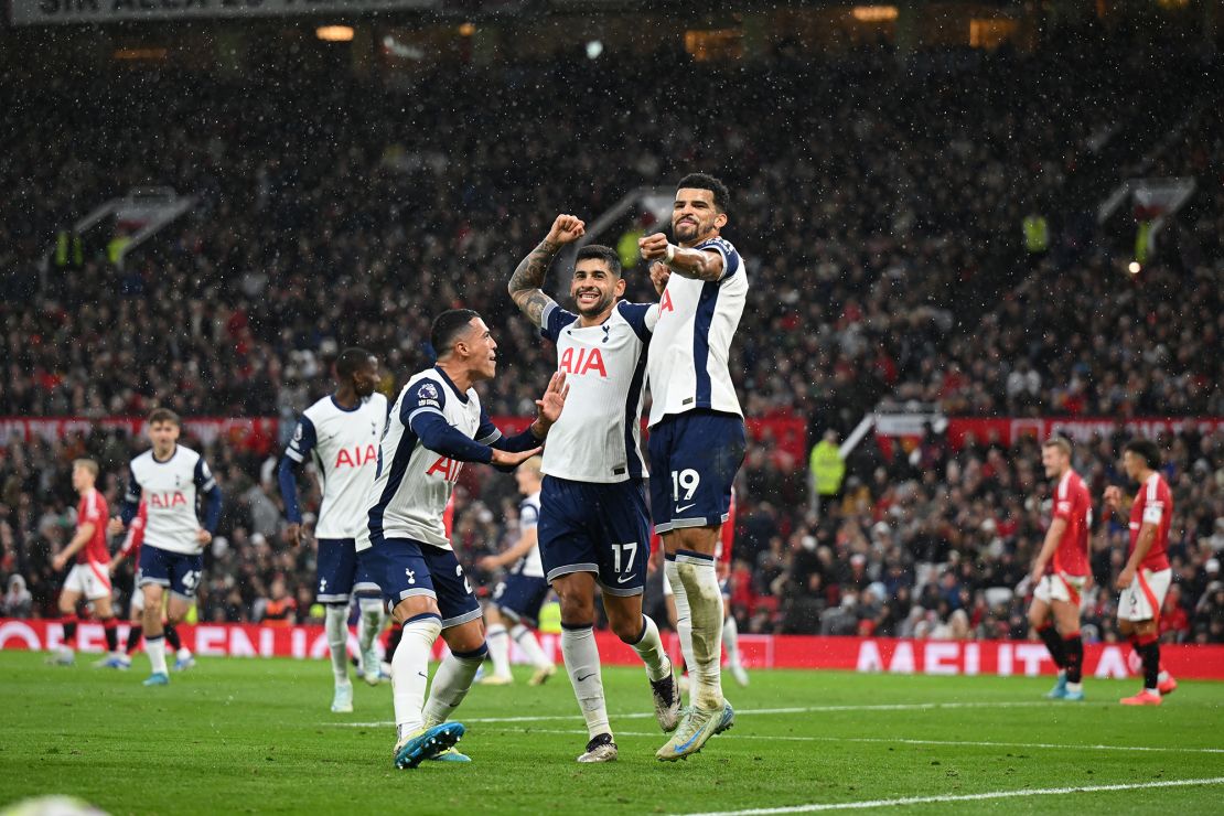 Tottenham players celebrate their third goal against United.