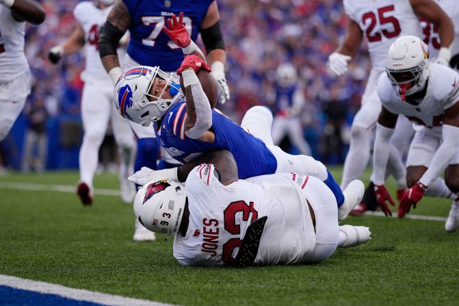 Buffalo Bills wide receiver Khalil Shakir, top, dives for the end zone for a touchdown as Arizona Cardinals defensive tackle Justin Jones is unable to make the tackle in Orchard Park, New York, on September 8. The Bills won 34-28.