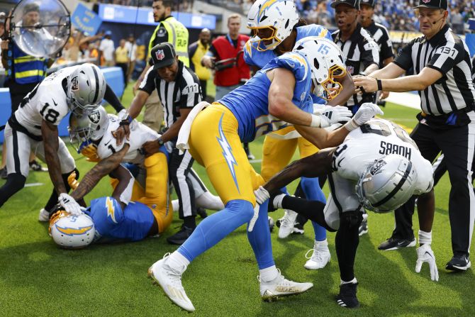 Los Angeles Chargers players and Las Vegas Raiders players clash after a play during the second half of their game in Inglewood, California, on Sunday, September 8.