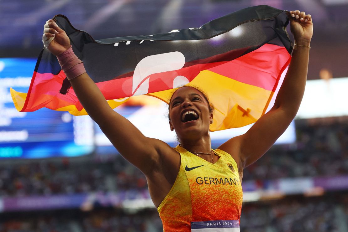 Yemisi Ogunleye of Germany celebrates with her national flag after winning gold